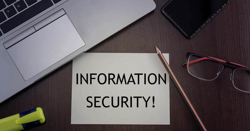 Laptop with post it note that says information security