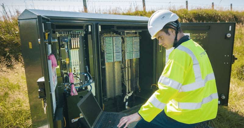 Engineer fixing roadside green cabinet